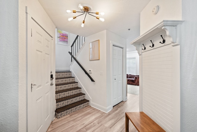 3901 Travis St Unit 121, Dallas, TX 75204 - staircase with a chandelier and wood finished floors