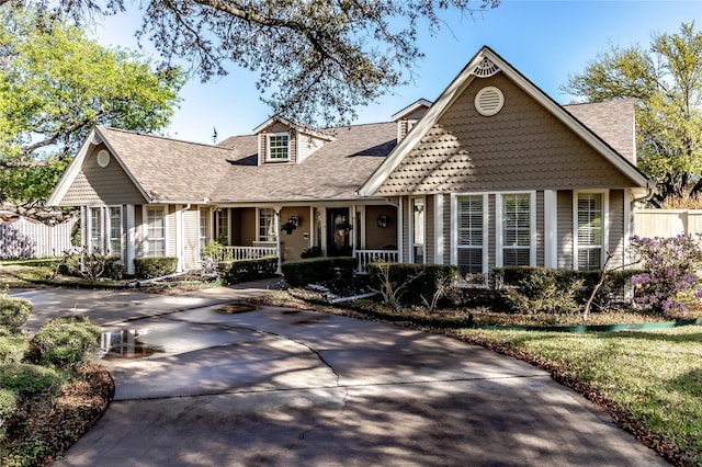 1470 Meandering Way, Rockwall, TX 75087 - view of front of house featuring covered porch, fence, and a shingled roof