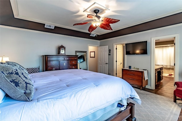 1470 Meandering Way, Rockwall, TX 75087 - bedroom featuring connected bathroom, a ceiling fan, visible vents, and wood finished floors