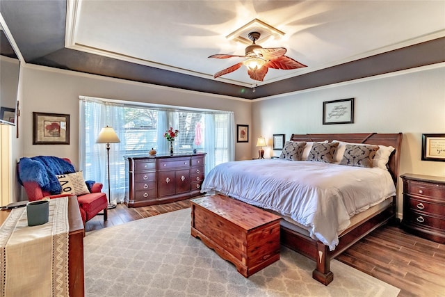 1470 Meandering Way, Rockwall, TX 75087 - bedroom with ornamental molding, a raised ceiling, ceiling fan, and wood finished floors
