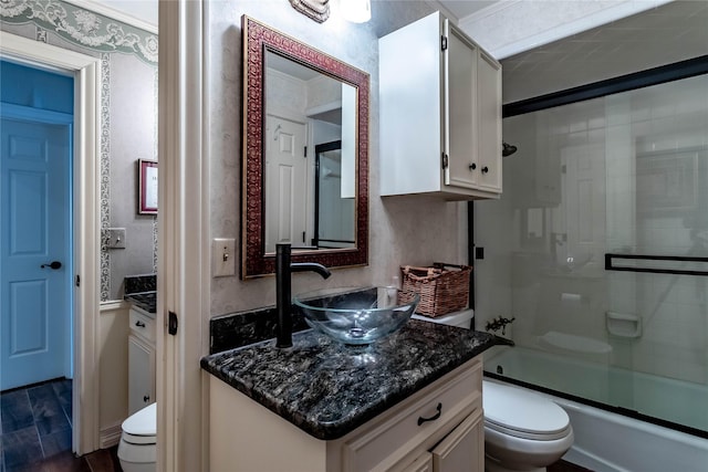 1470 Meandering Way, Rockwall, TX 75087 - bathroom featuring vanity, bath / shower combo with glass door, wood finished floors, and toilet