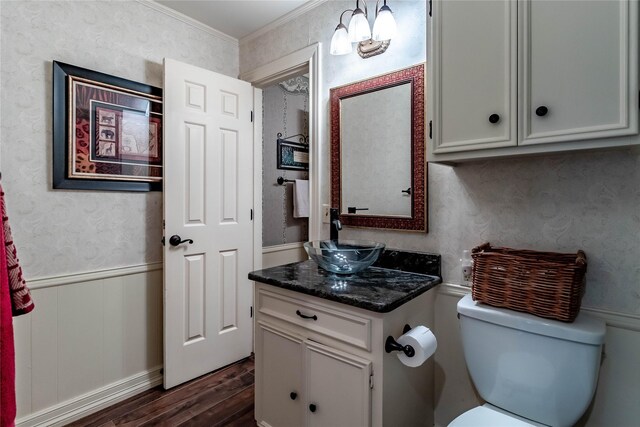 1470 Meandering Way, Rockwall, TX 75087 - half bath with wainscoting, vanity, toilet, wood finished floors, and ornamental molding