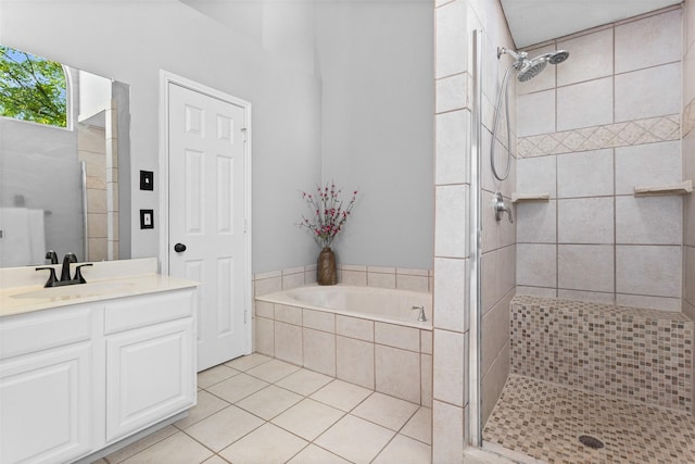 full bathroom featuring a stall shower, a garden tub, vanity, and tile patterned flooring