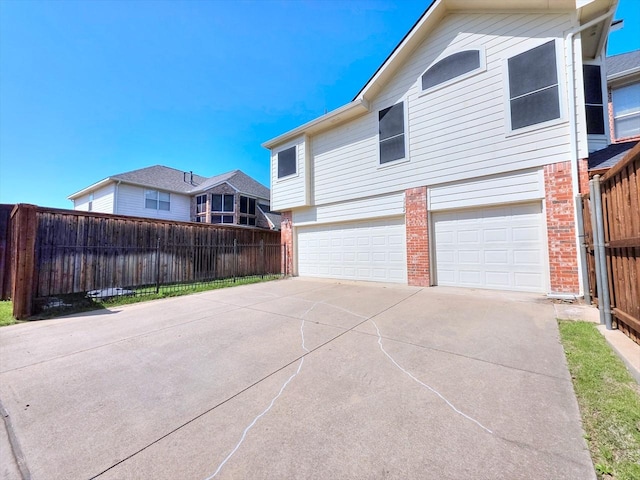 3304 Springbridge Ln, Plano, TX 75025 - view of home's exterior featuring a garage, brick siding, and concrete driveway