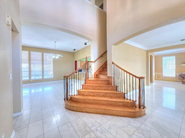3304 Springbridge Ln, Plano, TX 75025 - staircase with arched walkways, plenty of natural light, ceiling fan, baseboards, and crown molding