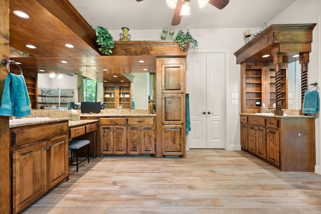 full bathroom featuring two vanities, recessed lighting, wood finished floors, a shower stall, and ceiling fan