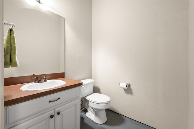 half bath featuring toilet and vanity