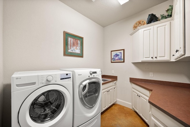 laundry room with light colored carpet, baseboards, cabinet space, and washer and clothes dryer