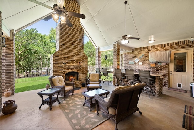 view of patio with fence, ceiling fan, and an outdoor brick fireplace