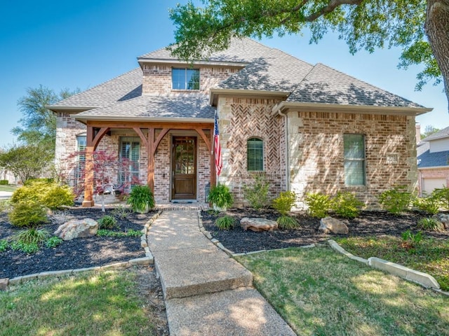 7212 Millard Pond Dr, Mckinney, TX 75071 - view of front of home with brick siding, a shingled roof, and covered porch