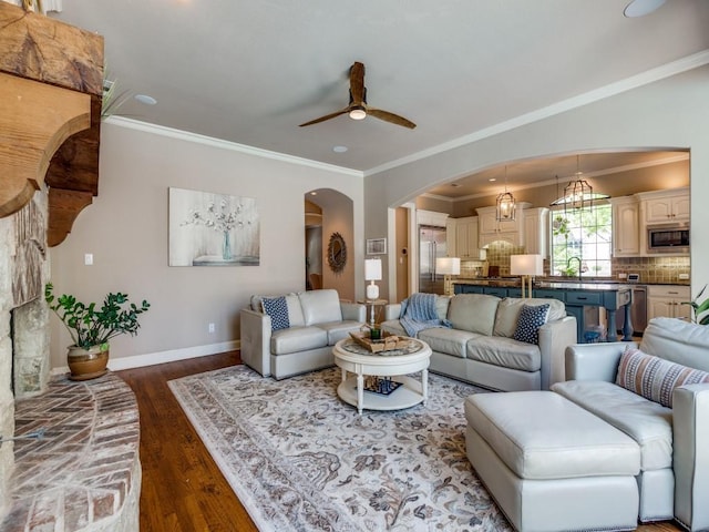 7212 Millard Pond Dr, Mckinney, TX 75071 - living room with arched walkways, wood finished floors, ceiling fan, and crown molding