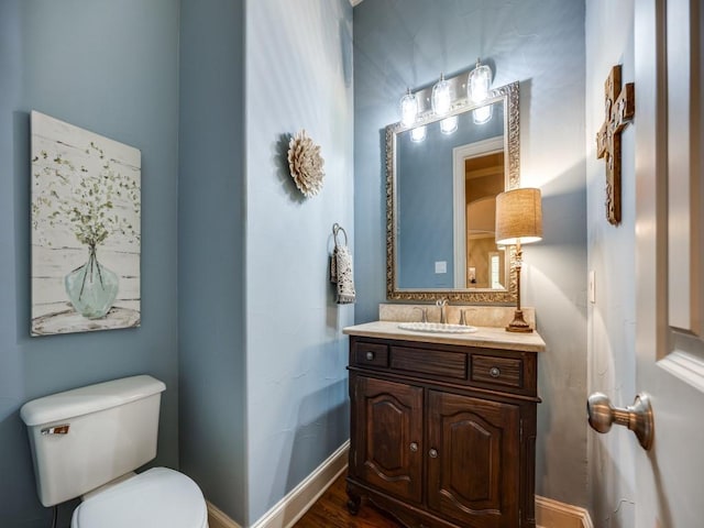 7212 Millard Pond Dr, Mckinney, TX 75071 - bathroom with toilet, wood finished floors, vanity, and baseboards