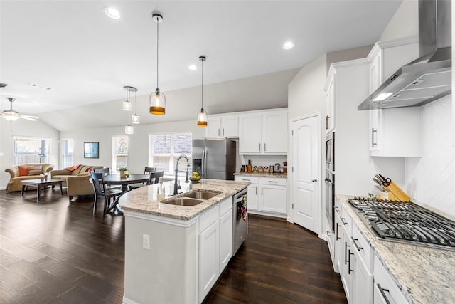 7600 W Fork Ln, Mckinney, TX 75071 - kitchen with wall chimney range hood, decorative backsplash, appliances with stainless steel finishes, a sink, and open floor plan