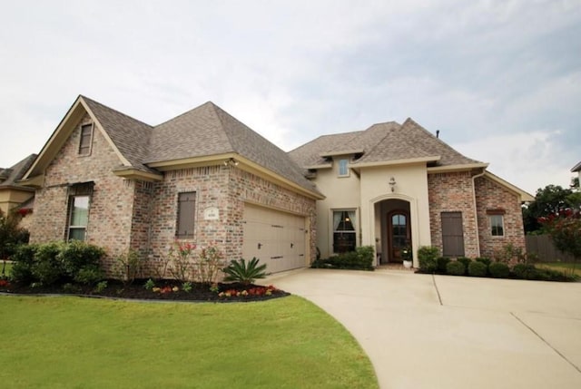 french provincial home with roof with shingles, concrete driveway, and brick siding
