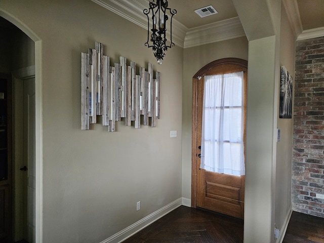 doorway to outside featuring baseboards, visible vents, ornamental molding, and arched walkways