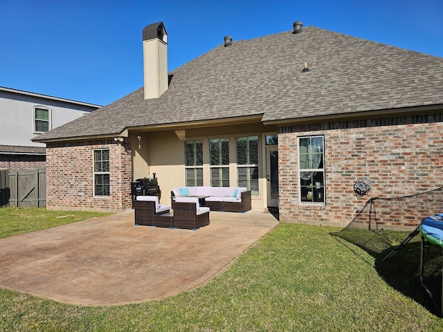 rear view of house with a patio area, outdoor lounge area, roof with shingles, fence, and brick siding