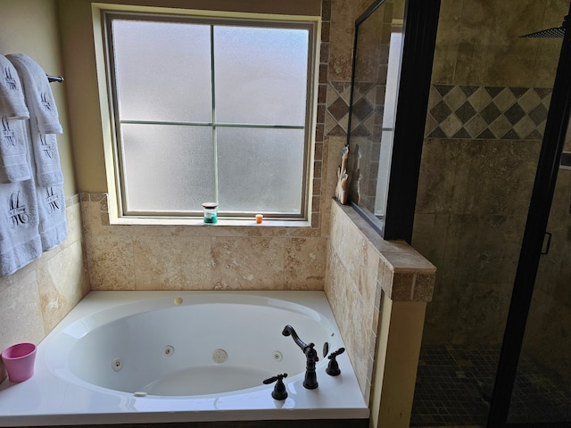 full bath featuring a whirlpool tub and a shower stall