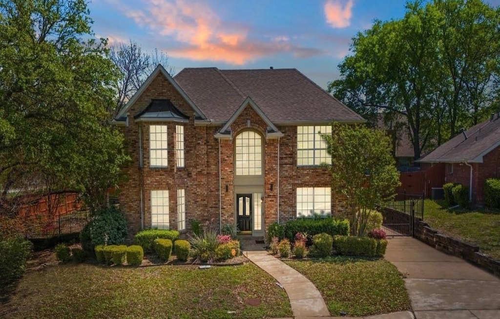 8304 Mountainview Dr, Dallas, TX 75249 - view of front of home with a gate, a front yard, and brick siding