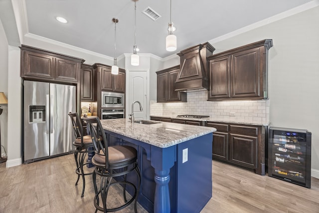 4112 Angelina Dr, Mckinney, TX 75071 - kitchen featuring appliances with stainless steel finishes, wine cooler, a sink, light wood-type flooring, and crown molding