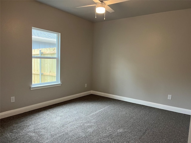 unfurnished room with dark carpet, baseboards, and ceiling fan