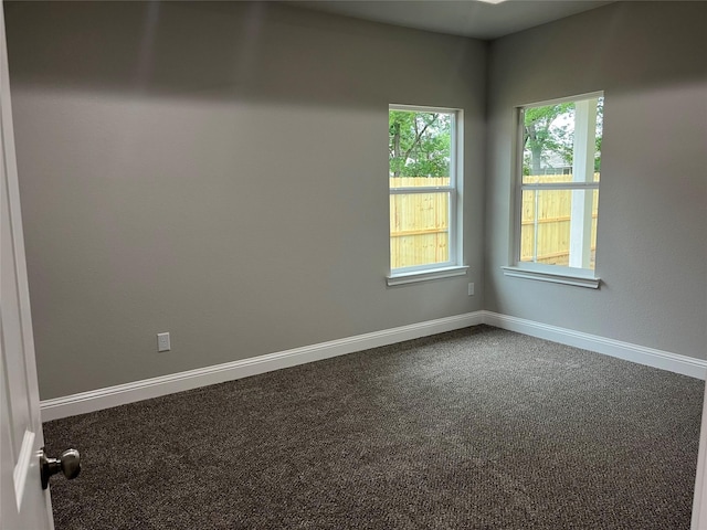 carpeted spare room with baseboards