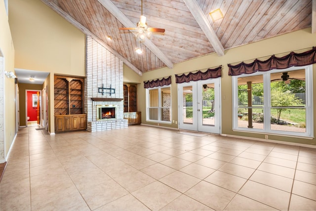 10019 Lost Oak Ridge Dr, Woodway, TX 76712 - unfurnished living room featuring ceiling fan, light tile patterned flooring, a brick fireplace, wood ceiling with exposed beams, and high vaulted ceiling