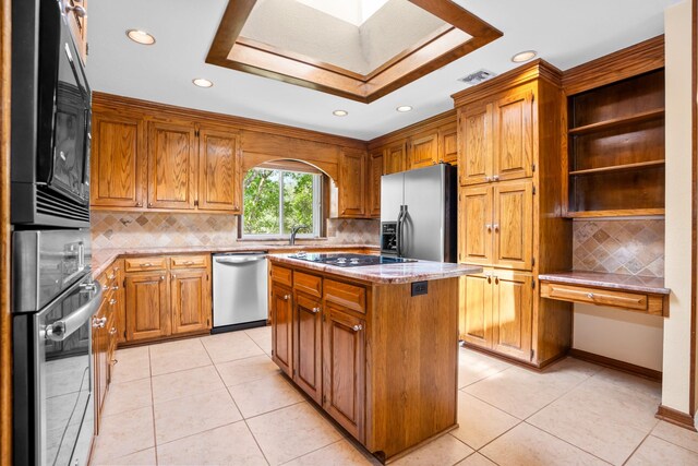 10019 Lost Oak Ridge Dr, Woodway, TX 76712 - kitchen with black appliances, recessed lighting, a center island, decorative backsplash, and brown cabinetry