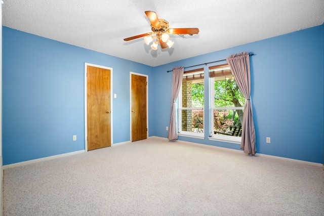 10019 Lost Oak Ridge Dr, Woodway, TX 76712 - unfurnished bedroom featuring carpet floors, baseboards, a ceiling fan, and a textured ceiling