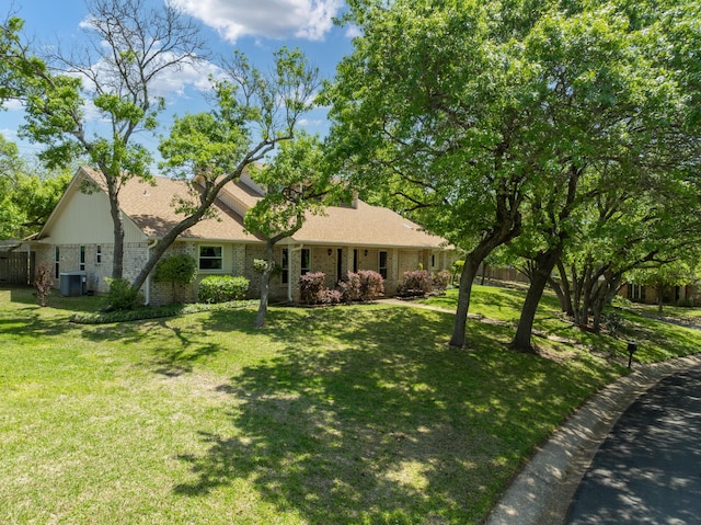 10019 Lost Oak Ridge Dr, Woodway, TX 76712 - view of front of house with brick siding, central air condition unit, and a front yard