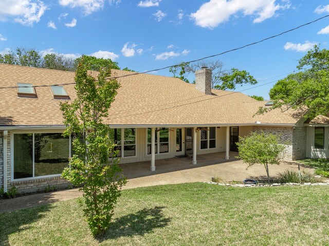10019 Lost Oak Ridge Dr, Woodway, TX 76712 - rear view of property with roof with shingles, a chimney, a lawn, brick siding, and a patio area