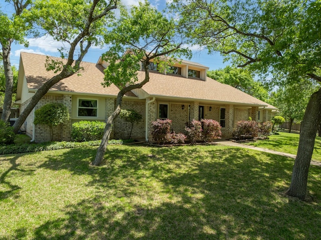 10019 Lost Oak Ridge Dr, Woodway, TX 76712 - view of front facade with a front lawn, a shingled roof, and brick siding