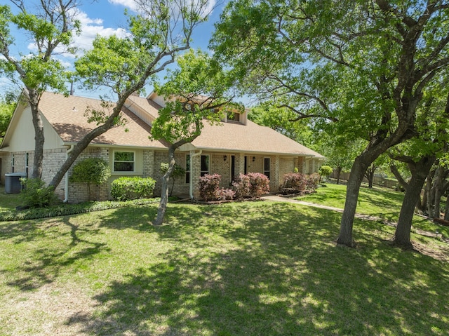 10019 Lost Oak Ridge Dr, Woodway, TX 76712 - view of front of property with brick siding, a front lawn, cooling unit, and roof with shingles