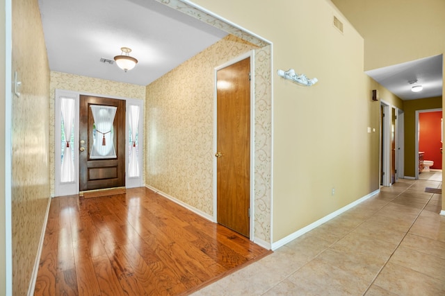 10019 Lost Oak Ridge Dr, Woodway, TX 76712 - foyer with wallpapered walls, baseboards, and wood finished floors