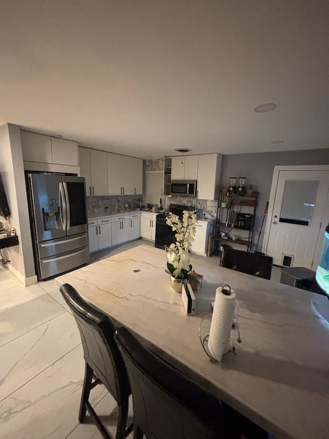 dining space with marble finish floor