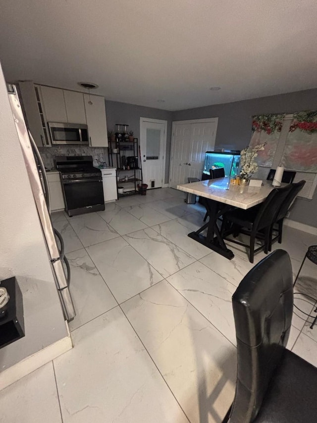 dining area with marble finish floor and baseboards