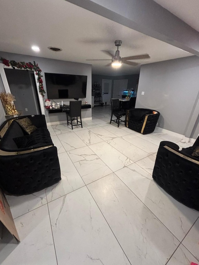 living area with marble finish floor, baseboards, a ceiling fan, and visible vents