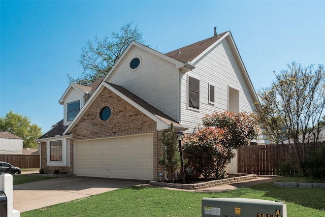 view of front of house with brick siding, driveway, fence, and a front yard