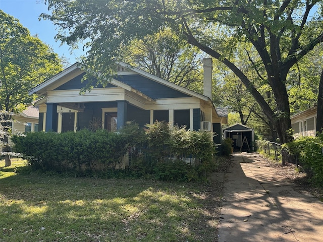 view of home's exterior featuring concrete driveway and a lawn