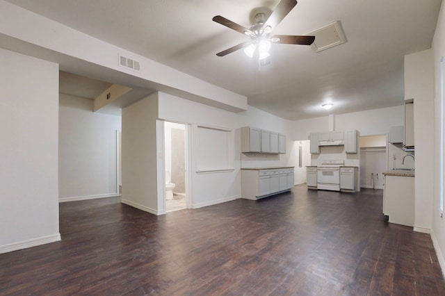 2311 Market Ave, Fort Worth, TX 76164 - unfurnished living room featuring visible vents, baseboards, a sink, ceiling fan, and dark wood finished floors