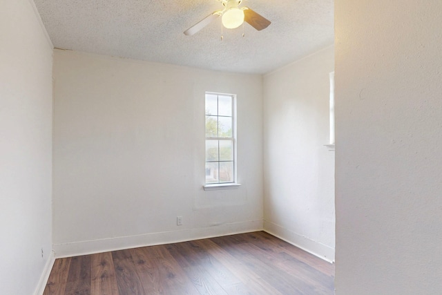 2311 Market Ave, Fort Worth, TX 76164 - unfurnished room featuring dark wood finished floors, a ceiling fan, baseboards, and a textured ceiling