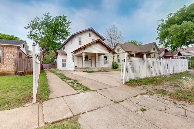 2311 Market Ave, Fort Worth, TX 76164 - bungalow-style home featuring a front yard, fence, and covered porch