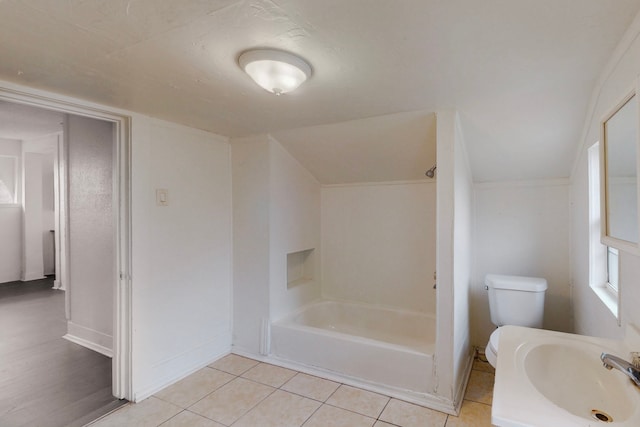 2311 Market Ave, Fort Worth, TX 76164 - full bathroom featuring tile patterned floors, toilet, baseboards, and  shower combination