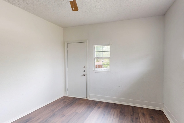2311 Market Ave, Fort Worth, TX 76164 - unfurnished room with baseboards, ceiling fan, and dark wood finished floors