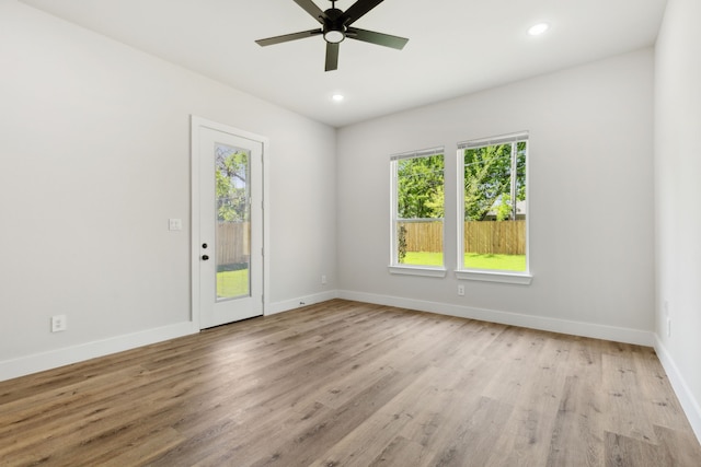 2239 Scotland Dr, Dallas, TX 75216 - unfurnished room featuring light wood-type flooring, baseboards, a ceiling fan, and a wealth of natural light