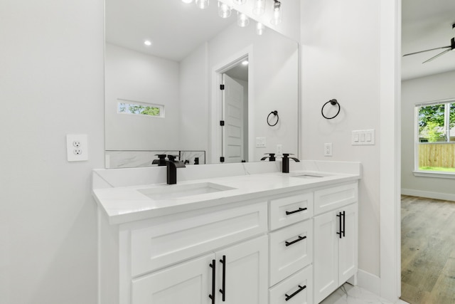 2239 Scotland Dr, Dallas, TX 75216 - bathroom featuring a sink, baseboards, and double vanity
