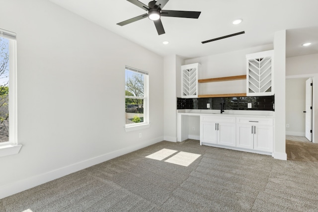 2239 Scotland Dr, Dallas, TX 75216 - interior space featuring a sink, white cabinets, open shelves, and light colored carpet