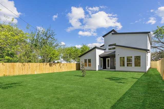 2239 Scotland Dr, Dallas, TX 75216 - rear view of house featuring a fenced backyard and a lawn