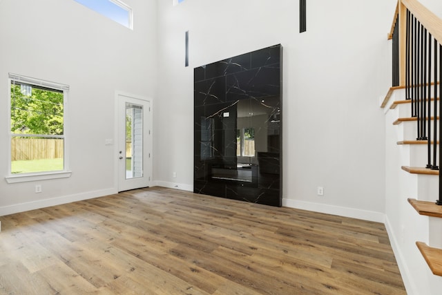 2239 Scotland Dr, Dallas, TX 75216 - entrance foyer featuring baseboards, stairway, a high ceiling, and wood finished floors