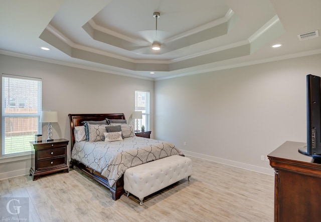 262 Poydras Ave, Bossier City, LA 71111 - bedroom with crown molding, a tray ceiling, visible vents, light wood finished floors, and baseboards