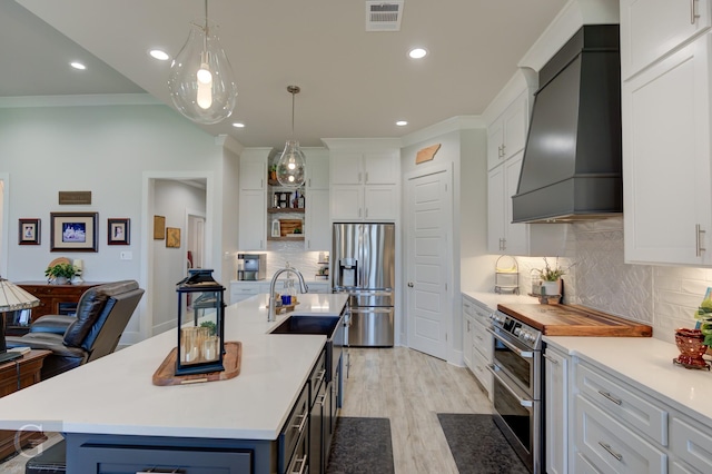 262 Poydras Ave, Bossier City, LA 71111 - kitchen featuring custom exhaust hood, visible vents, light countertops, and appliances with stainless steel finishes